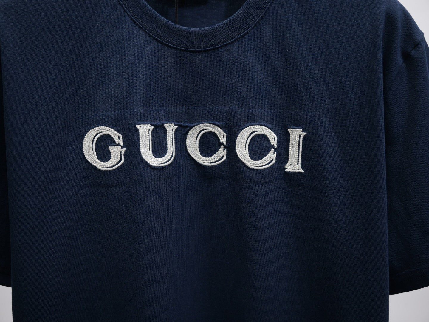 Dark navy short-sleeve T-shirt with large GUCCI logo on the chest