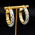 Louis Vuitton monogram hoop earrings on stand, gold and multicolor pattern