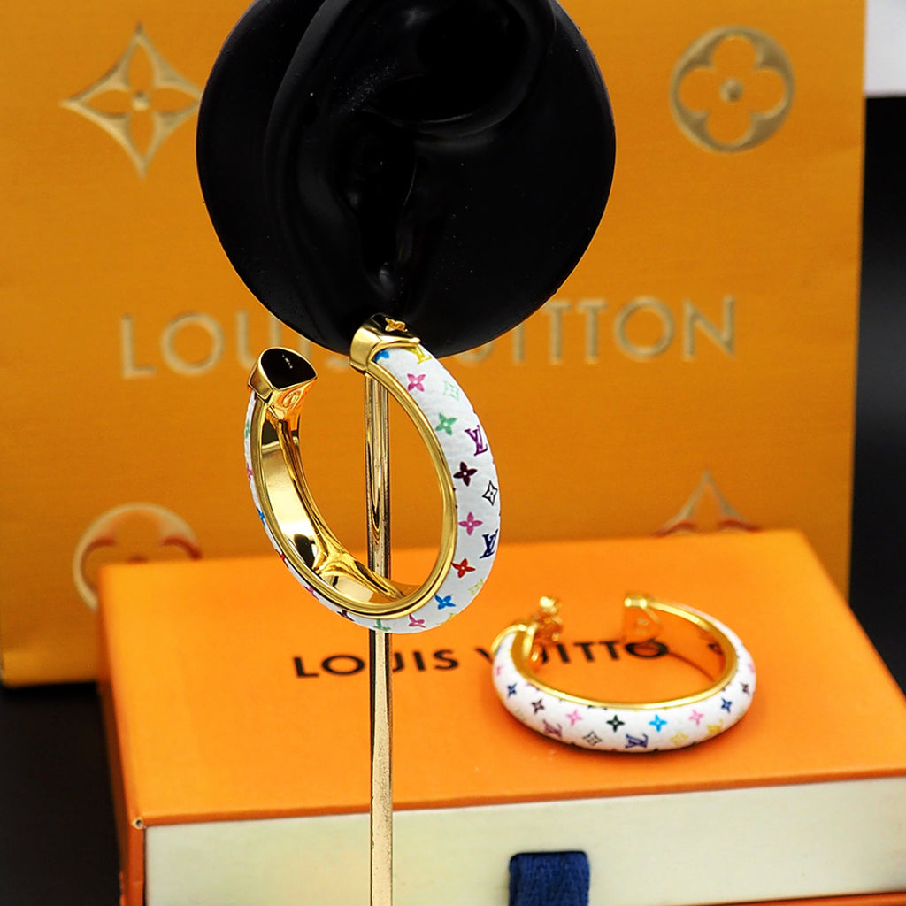 Louis Vuitton monogram hoop earrings on display stand with gold interior