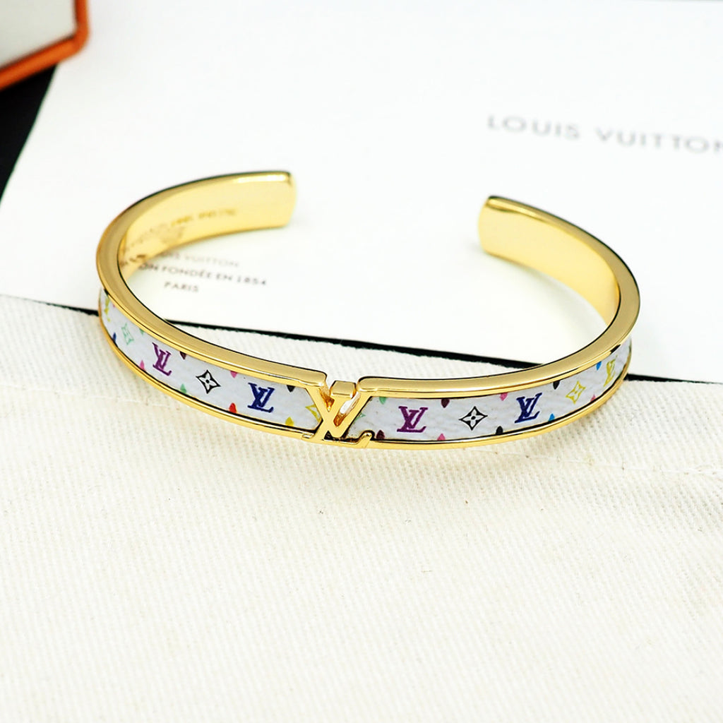 Louis Vuitton monogram cuff bracelet, gold-tone interior and multicolor logo strip