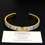 Louis Vuitton cuff bracelet with gold-tone trim and blue monogram pattern