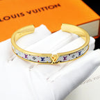 Louis Vuitton monogram cuff bracelet, gold-tone clasp with multicolor logo band