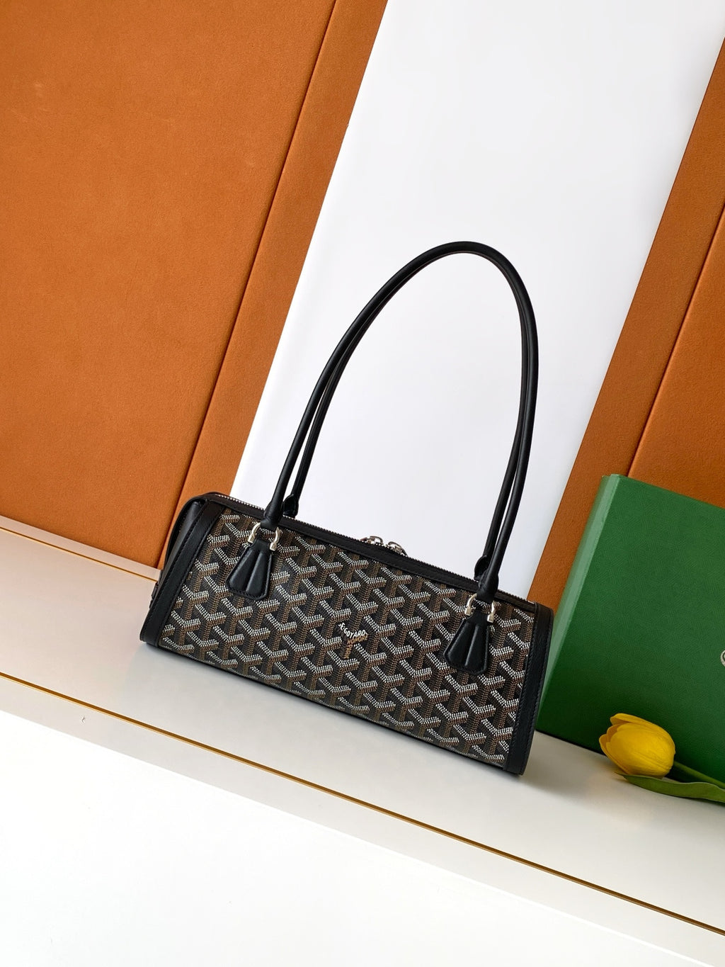 Goyard bag with top handles, black monogram canvas, and leather front trim.