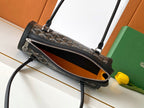 Goyard bag with zipper front pocket, black interior view, and adjustable shoulder strap.