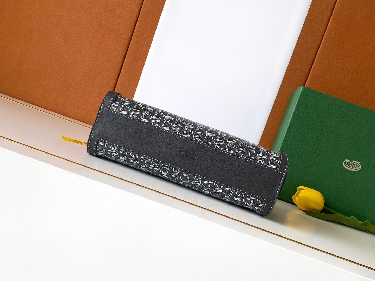 Monogram clutch bag with dark flap and front button detail