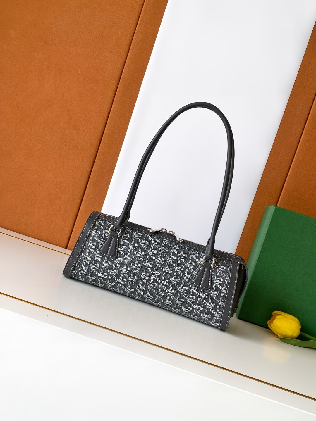 Monogram tote bag with curved black handles and structured top