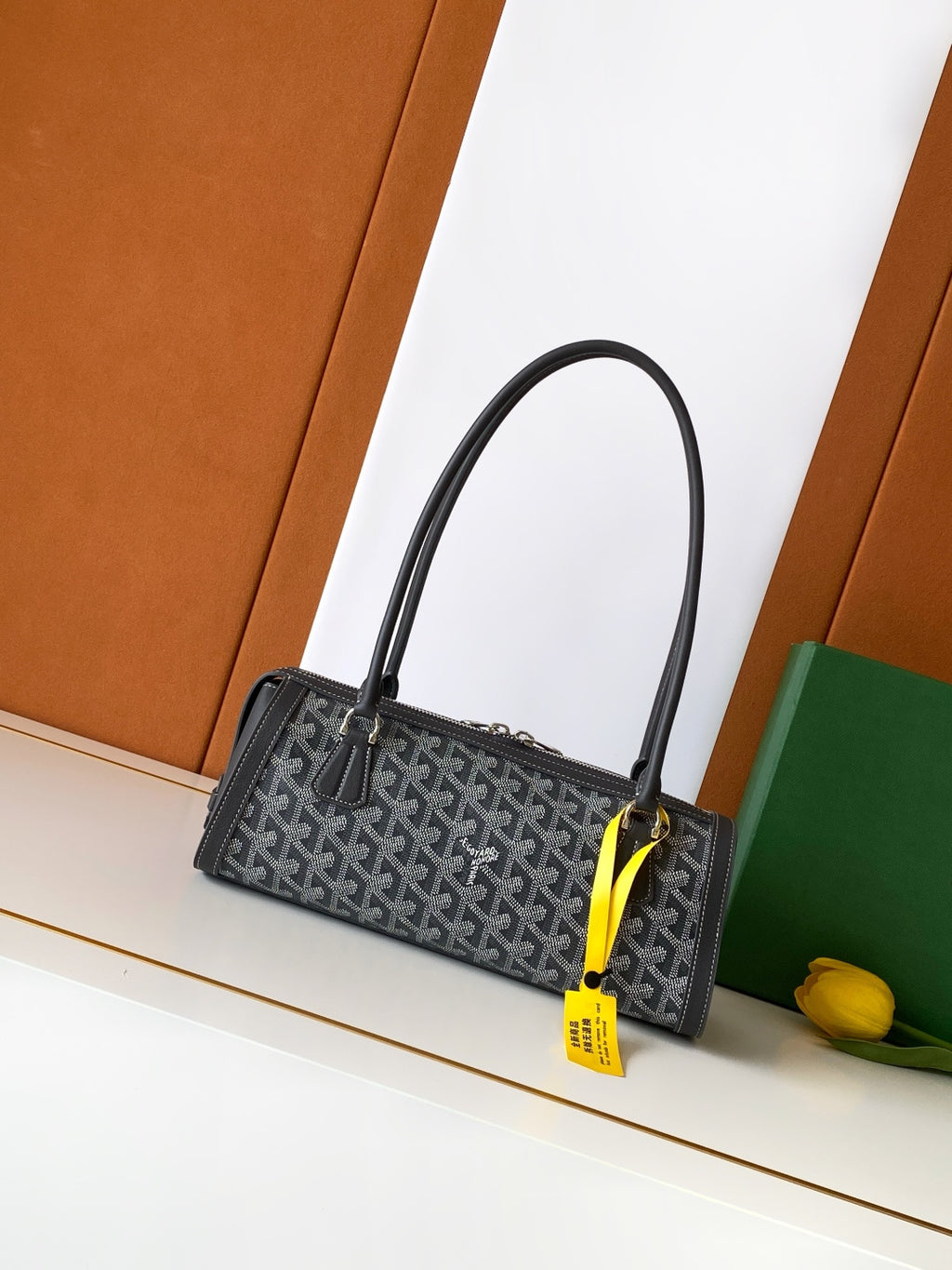 Small monogram tote bag with black handles and gold zipper hardware