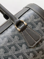 Monogram canvas handbag corner with stitched leather strap and gold buckle