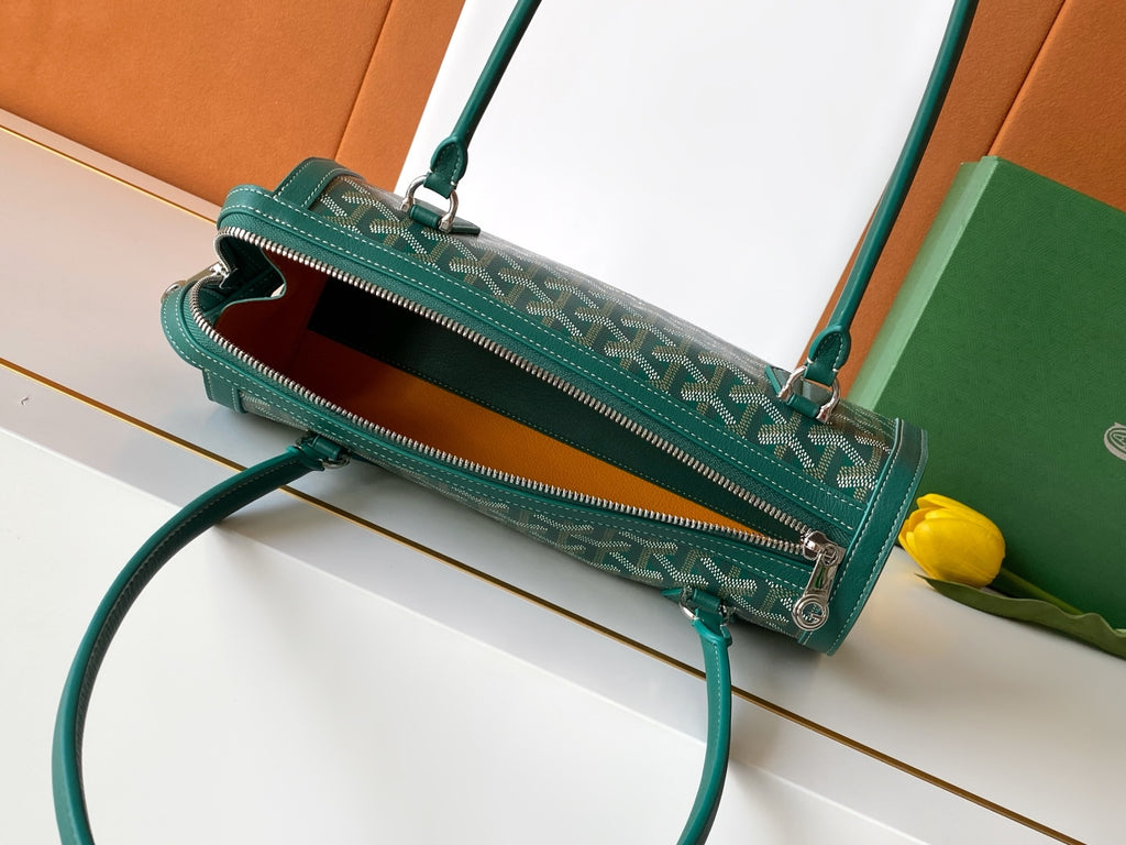 Goyard zip-top bag, dark green patterned exterior with open zipper and teal strap