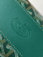 Goyard embossed logo on dark green leather panel with stitched edge