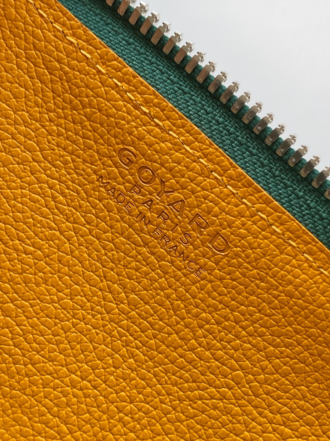 Goyard interior leather label, yellow panel with embossed logo near zipper