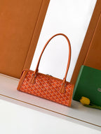 Orange patterned Goyard tote bag with structured shape and top handles