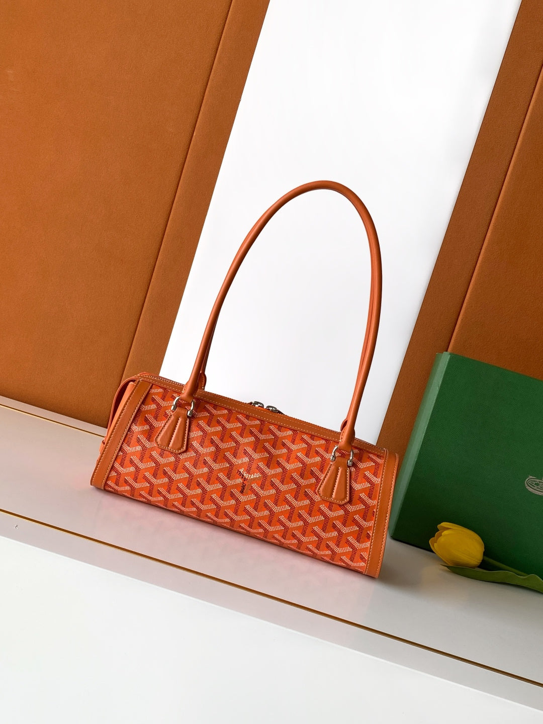 Orange patterned Goyard tote bag with structured shape and top handles