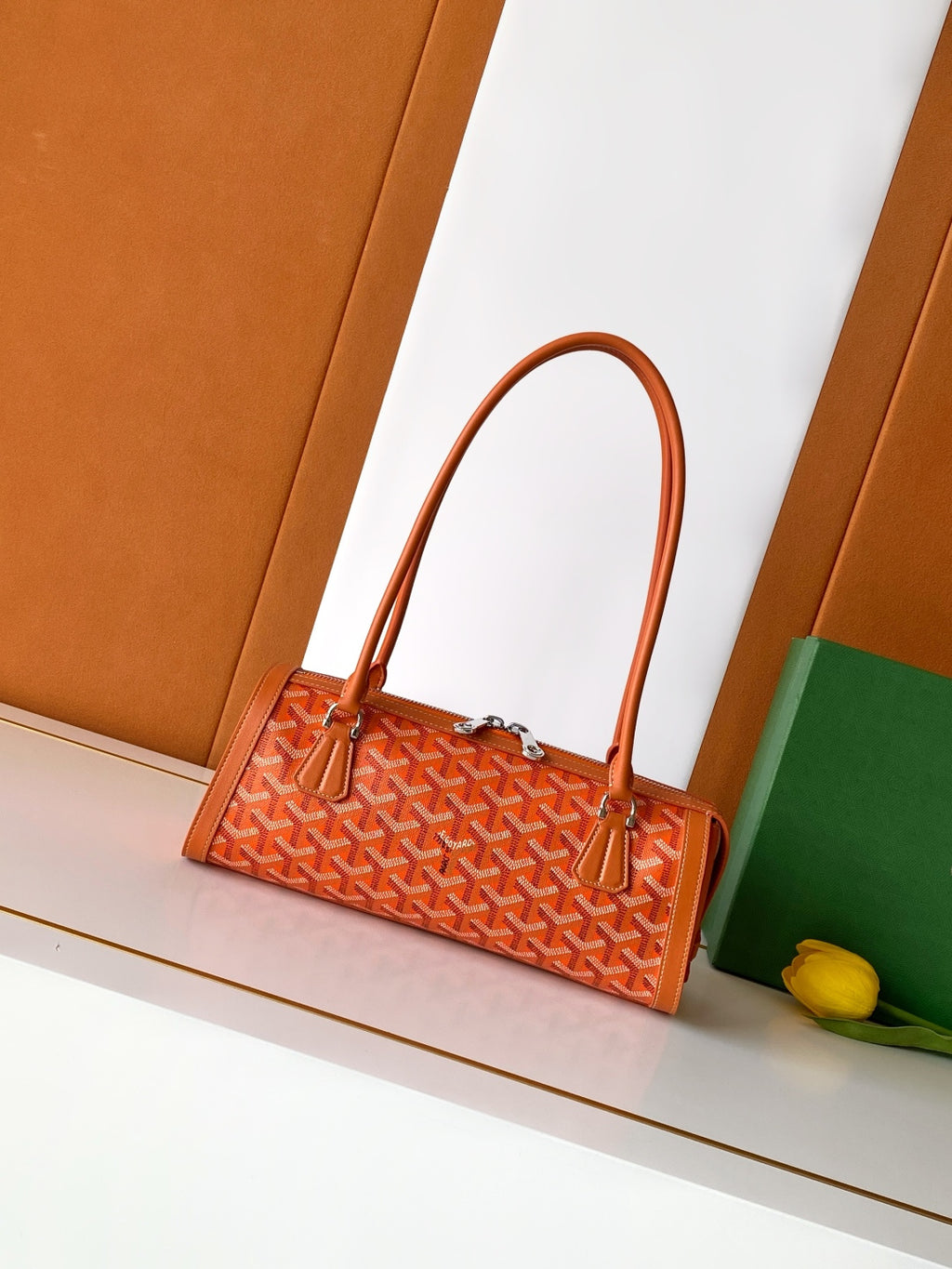 Orange patterned Goyard tote bag with top handles and silver-tone hardware
