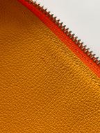 Golden leather lining with orange zipper trim on a Goyard bag