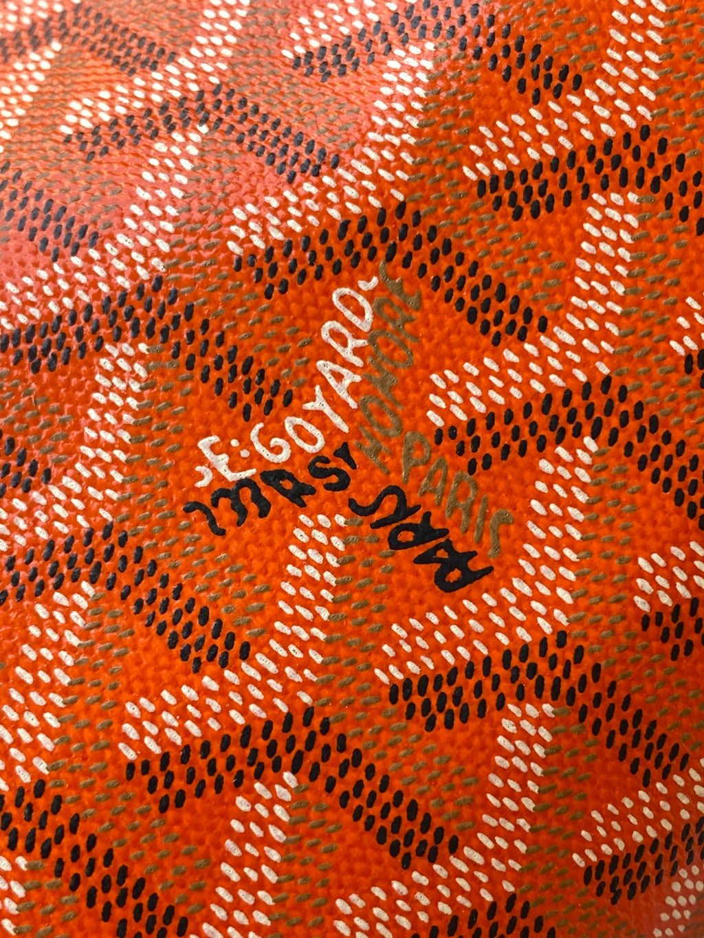 Orange patterned Goyard lining with 'Goyard' logo print