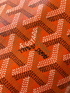 Orange patterned Goyard lining with 'Goyard' logo print