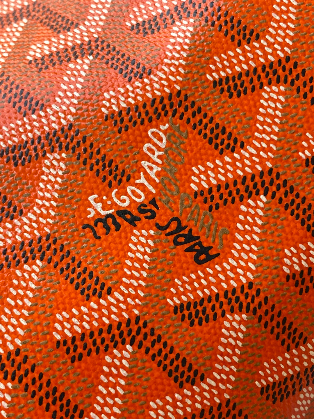 Orange patterned Goyard lining with 'Goyard' logo print