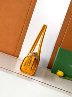 Goyard yellow monogram handbag side view with rolled top handles
