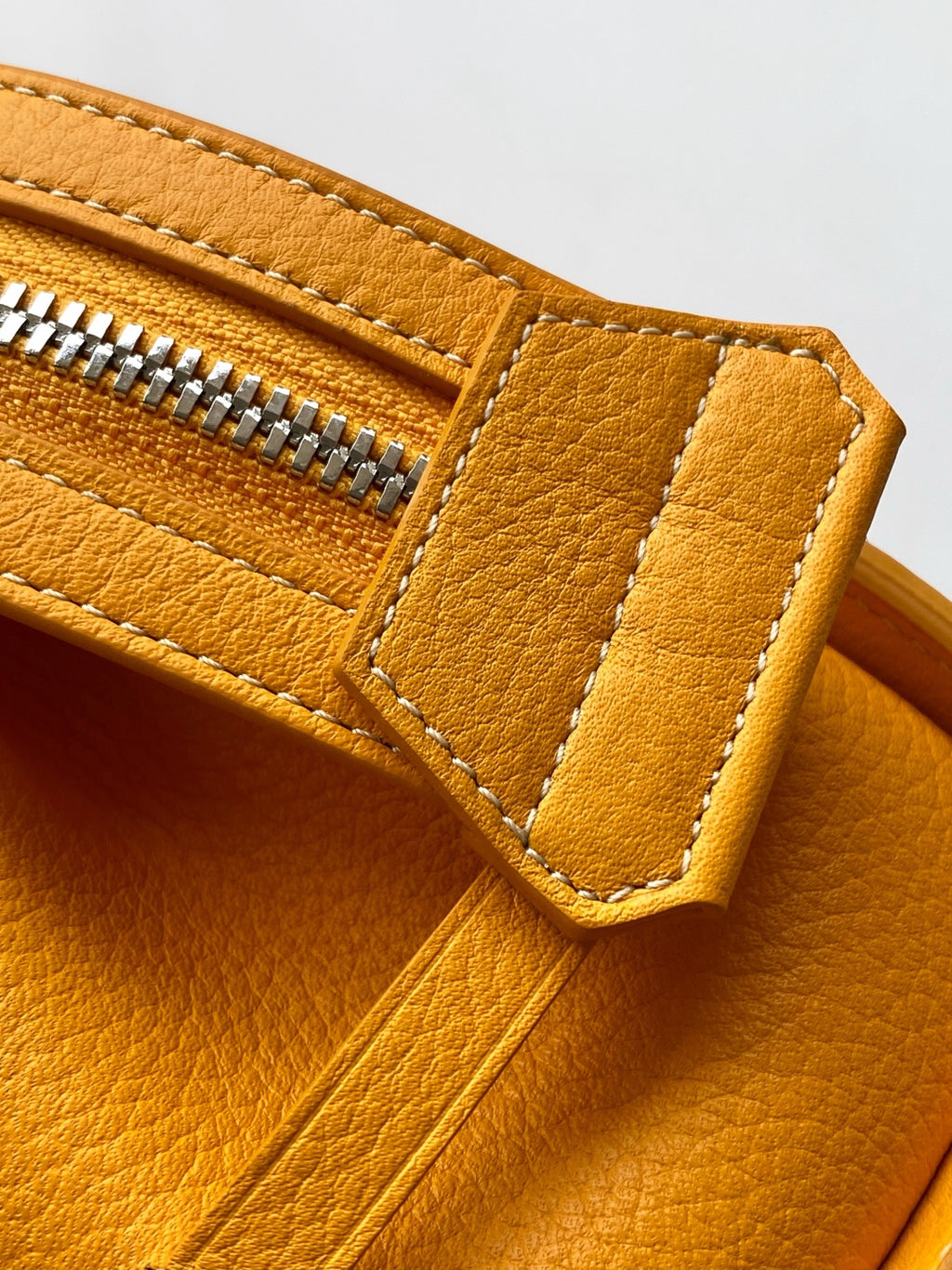 Goyard yellow leather handbag close-up of zipper pocket and strap detail