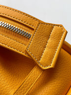 Goyard yellow leather handbag close-up of zipper pocket and strap detail