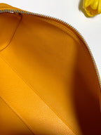 Goyard yellow leather handbag interior panel close-up with zipper edge