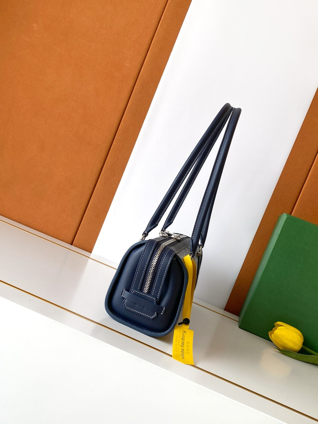 Goyard bag in navy with double handles and structured front, top zip closure.