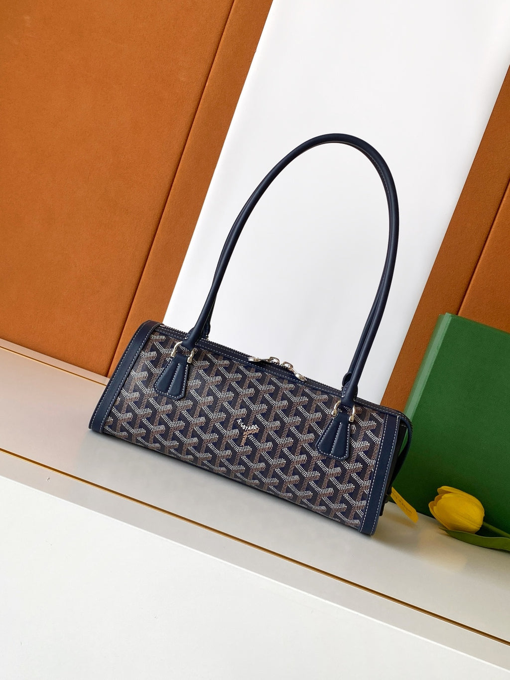 Goyard bag with navy patterned canvas, navy leather handles, top zip closure.