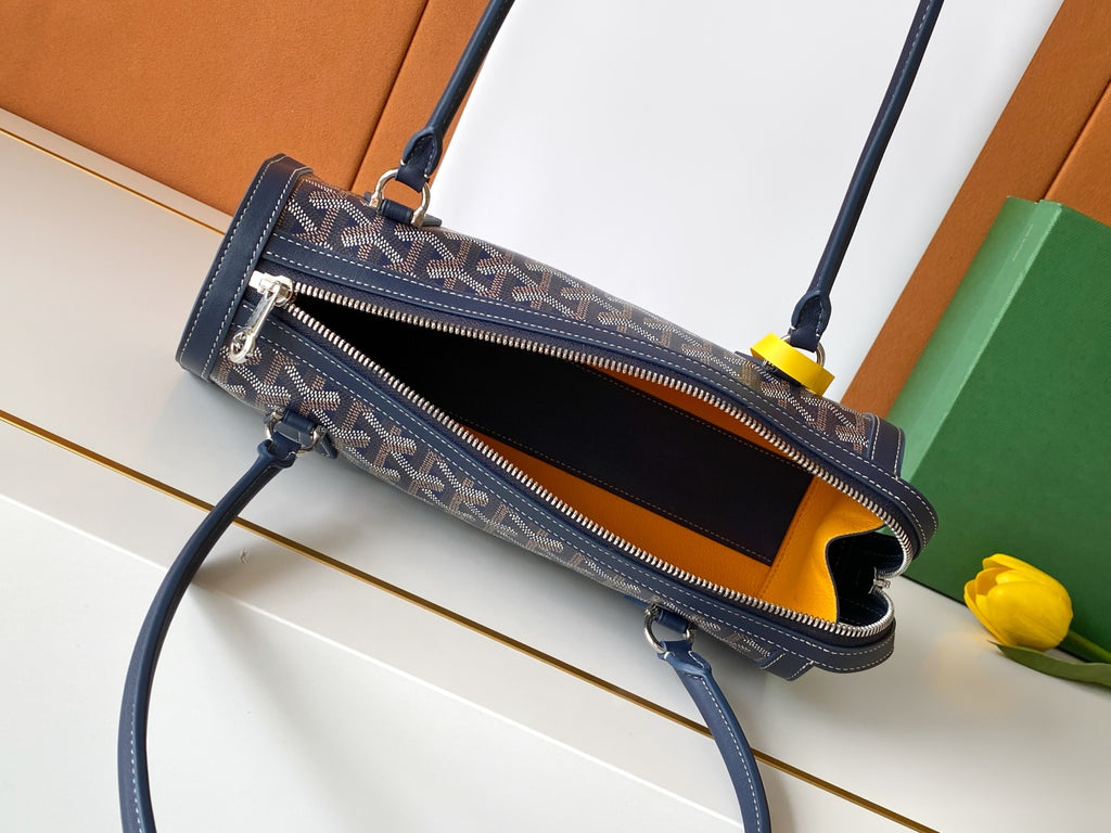 Goyard bag with open top, navy patterned exterior, dual zippers, leather edging.