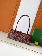 Goyard bag in burgundy with geometric logo pattern and top handles