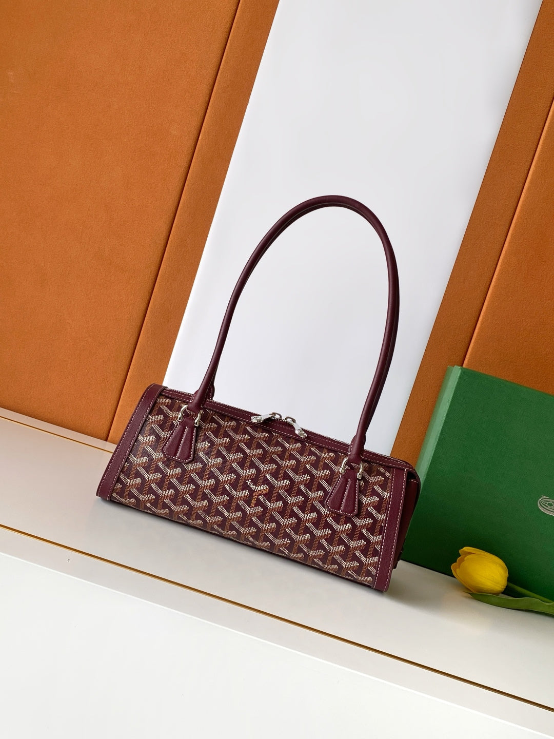 Goyard bag in burgundy with geometric logo pattern and top handles