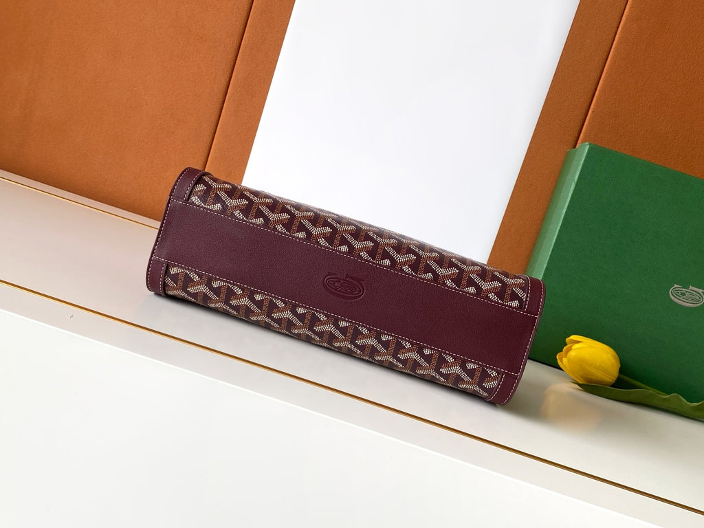 Burgundy patterned bag with top flap and stitched trim