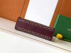 Burgundy patterned bag with top flap and stitched trim