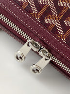 Burgundy zip pocket detail with silver hardware and stitched edge