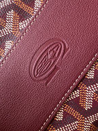 Burgundy leather panel with embossed oval logo and contrast stitching