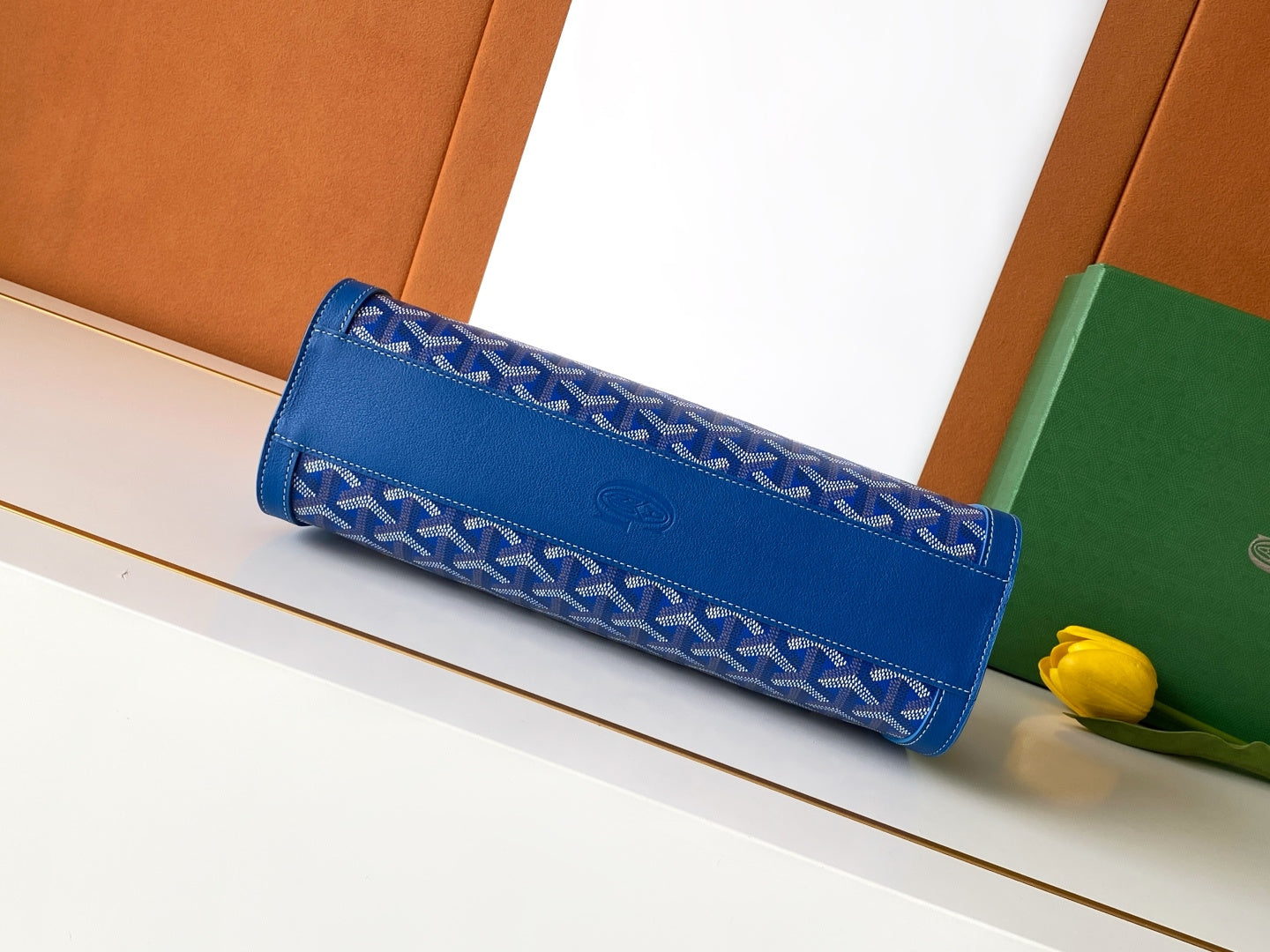 Blue Goyard patterned clutch bag with flap and long rolled silhouette