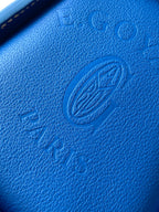 Blue textured leather panel with embossed Goyard logo stamp