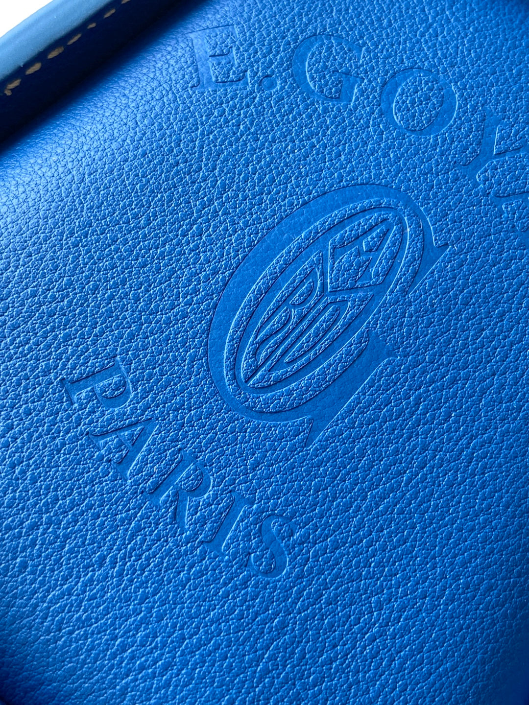 Blue textured leather panel with embossed Goyard logo stamp