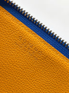 Mustard-yellow leather lining with embossed Goyard logo and blue zipper trim