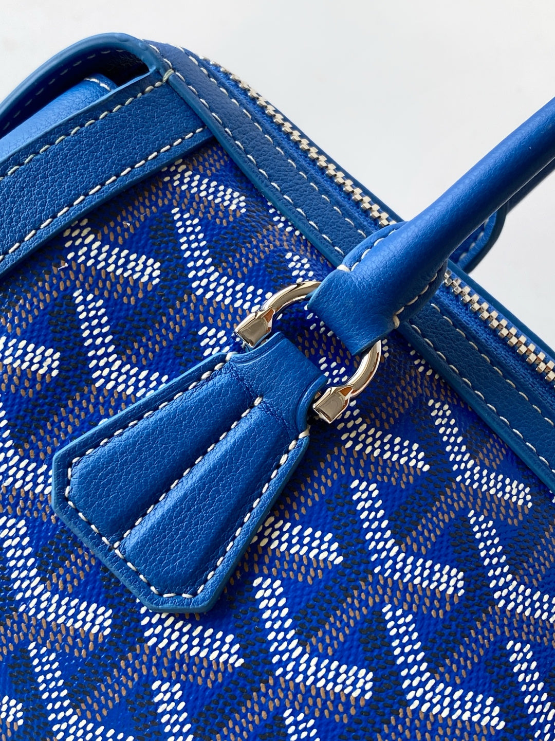 Blue patterned interior with zip pocket, stitched trim, and leather tab