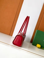 Red zip-top handbag with structured sides and short handle straps
