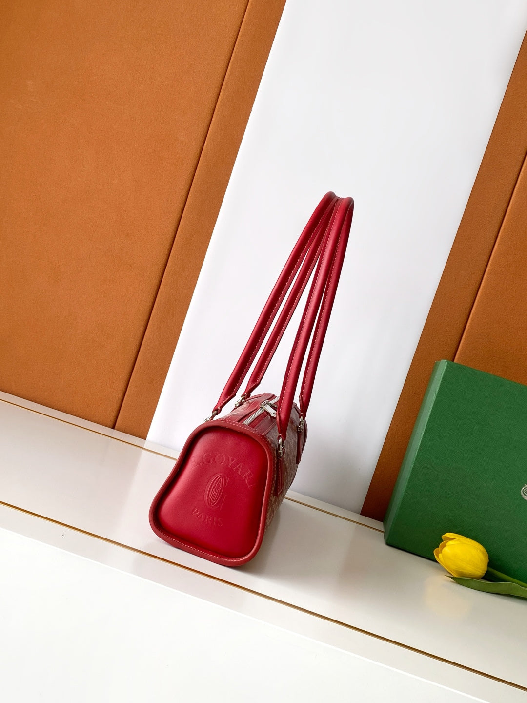 Red zip-top handbag with structured sides and short handle straps