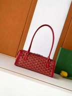 Red Goyard-style tote bag with top handles and front patterned canvas