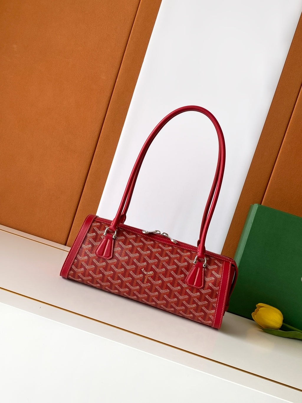 Red Goyard-style tote bag with top handles and zip closure, front patterned canvas