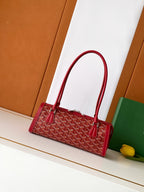 Red Goyard-style tote bag with top handles and zip closure, front patterned canvas