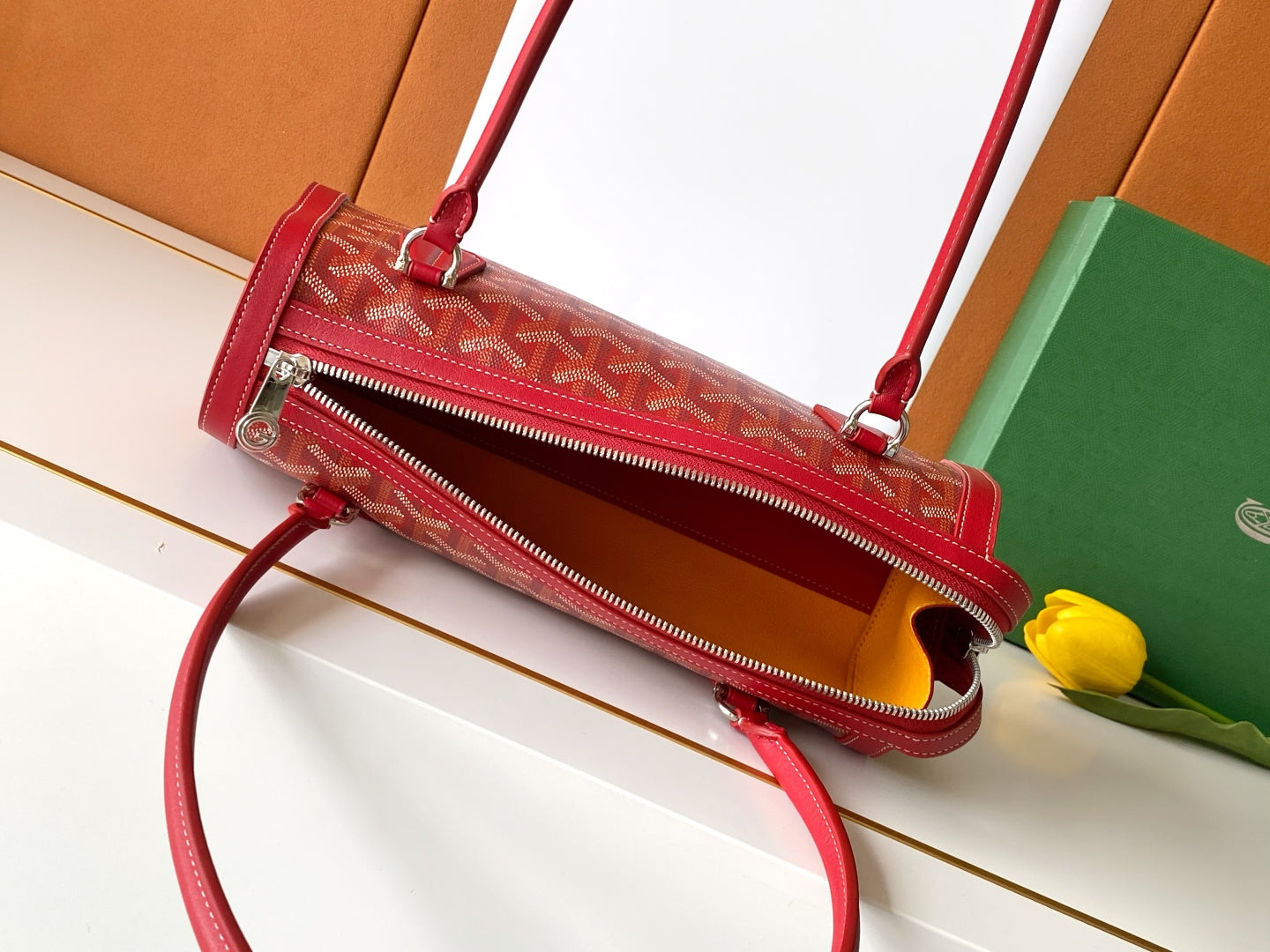 Red patterned zip-top handbag with crossbody strap and top handle
