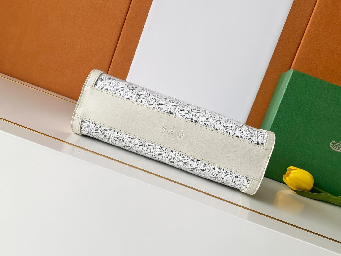 Goyard white foldover bag with long handle and embossed logo patch