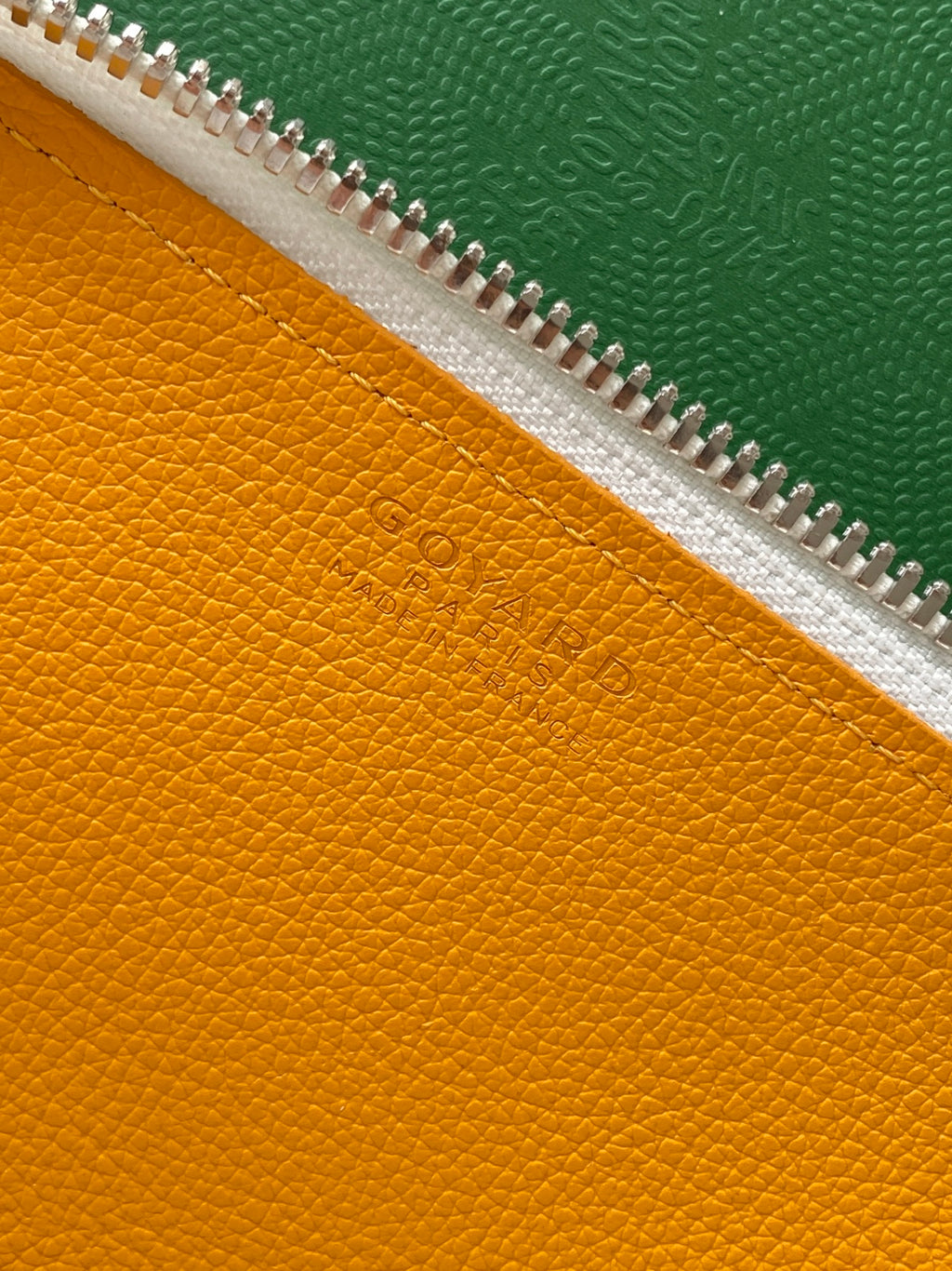 Goyard yellow leather lining with zipper track and embossed logo