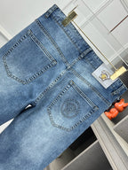 Versace denim jeans front with large logo patch and stitched side pockets