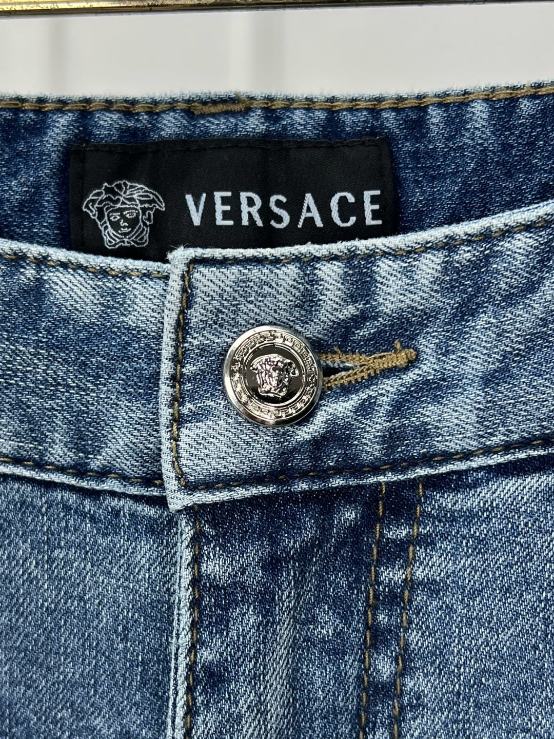 Versace denim jeans back waistband label with logo emblem and VERSACE text